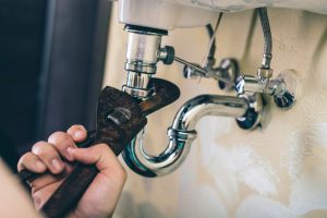 Plumber doing repair work on a drain.